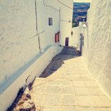 vintage photo of narrow street in Lindos. Rhodes, Greece 