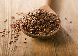Flax seeds heap on a wooden spoon 