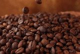Coffee beans on table on brown background 