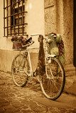 Vintage bicycle leaning against an old door in a medieval street 