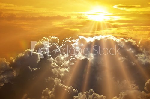 Dramatic impressive background - sky with bright sun and dark cl