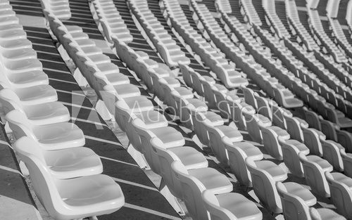Empty seats at soccer stadium , black and white