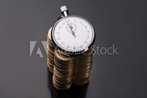 Stopwatch on stack of euro coins