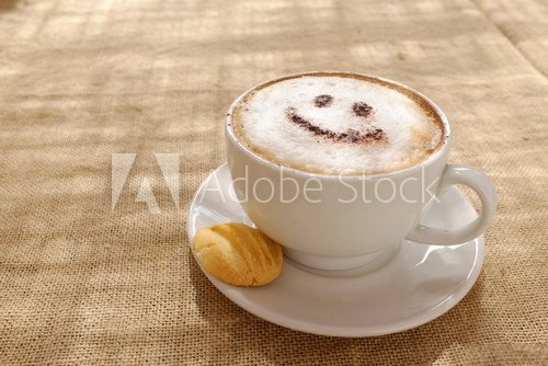 Coffee cappuccino with foam or chocolate smiling happy face