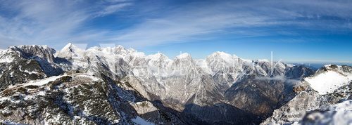 Photo of a beautiful scene in European Alps. A view on the snow covered Kamnisko Savinjske alpe from the mountain Vrh Korena (altitude 1999 m).