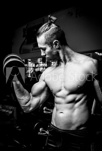 Young muscular man in gym