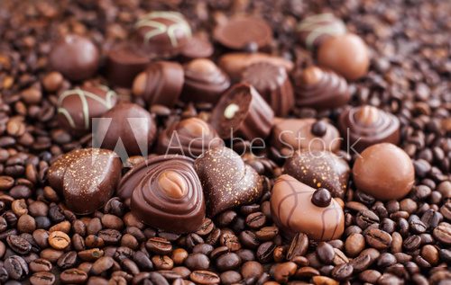 Assorted chocolate pralines on coffee beans background