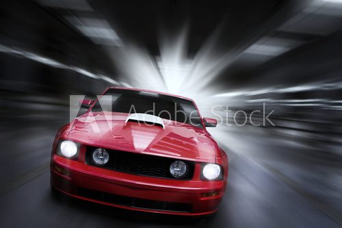 Luxury red sport car speeding in a underground parking