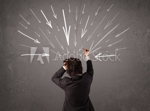 Business man with hand drawn arrows pointing at his head