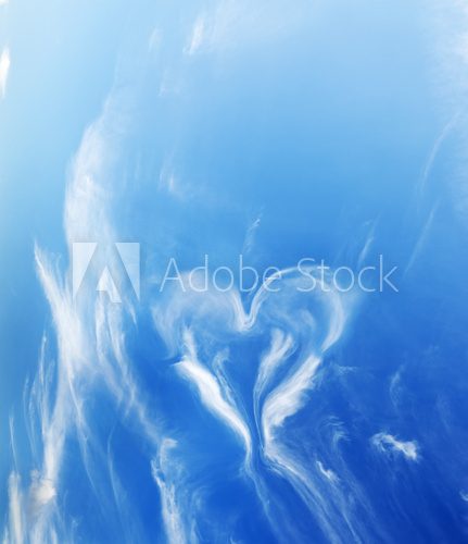 Heart shaped cloud on blue sunny sky.