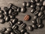 Coffee crop beans on wood texture background 