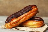 Tasty eclairs on wooden table, close up 