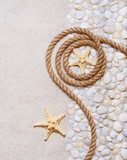 Rope and starfish on the sea pebbles