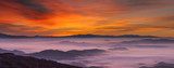 Idyllic mountain landscape at foggy dawn