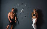 Sport time. Concept. Athletes posing with clock