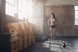 Fit young woman walking in the crossfit gym