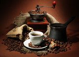 cup of coffee, grinder, turk and coffee beans 