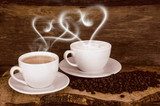Coffee beans and coffee cup with heart- shaped steam 