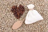 Sack with coffee on green coffee beans background 