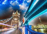 Night over Tower Bridge in London. Blue shapes of metal structur 