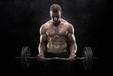 Young muscular man lifting weights over dark background 