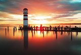 Beach sunrise with lighthouse 