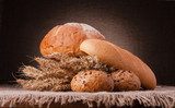 Loaf of bread and wheat ears still life 