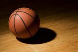 Basket ball sitting on wood floor 