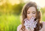 Beautiful spring girl with flowers on the meadow 