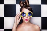 Attractive surprised young woman wearing sunglasses 