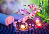 heart of stones massage with candles, orchids, towels and bamboo 