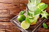 Fresh mojito drinks on wooden background 
