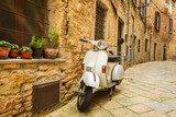 Old Vespa scooter on the street in Italy 