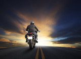 young man riding big bike motocycle on asphalt high way against 