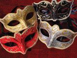 Looking down on some masquerade mask on red background 