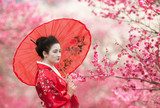 Asian style portrait of a woman with red umbrella 