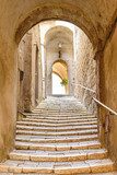 old stone steps and arch in the medieval village, Pitigliano, tuscany, italy