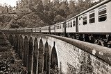 Sepia toned photo of train running on the Nine Arch Bridge, Demodara, Sri Lanka
