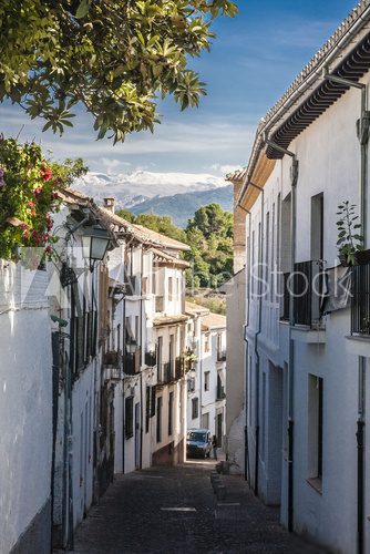 The narrow street with old houses, Granada, Spain.