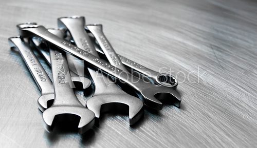 Wrenches on the scratched metal background.
