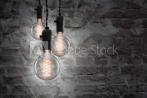 Idea concept - Vintage incandescent bulbs on wall background