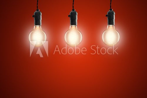 Idea concept - Vintage incandescent bulbs on red background