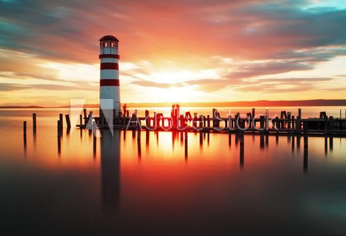 Beach sunrise with lighthouse