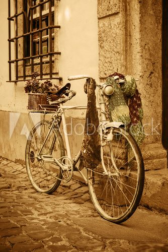 Vintage bicycle leaning against an old door in a medieval street
