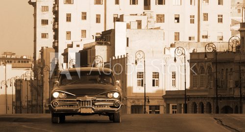 A classic car driving the Malecon, Havana, Cuba