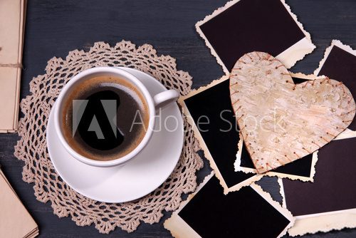 Composition with coffee cup, letters and old blank photos,