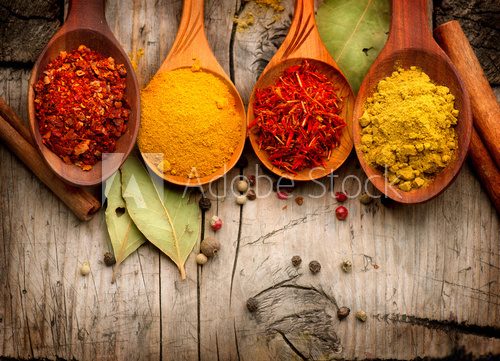 Spices and herbs. Curry, saffron, turmeric, cinnamon over wood