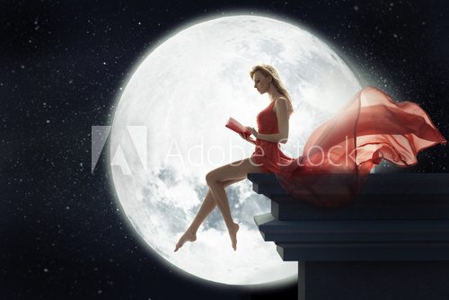 Cute woman over full moon background