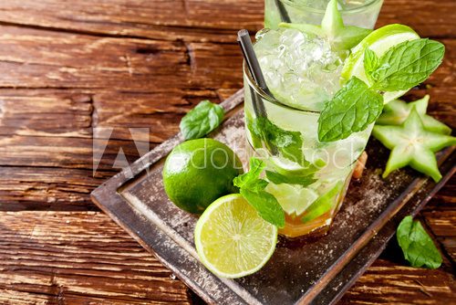 Fresh mojito drinks on wooden background