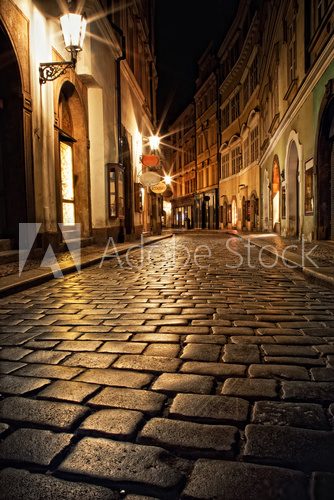 narrow alley with lanterns in Prague at night